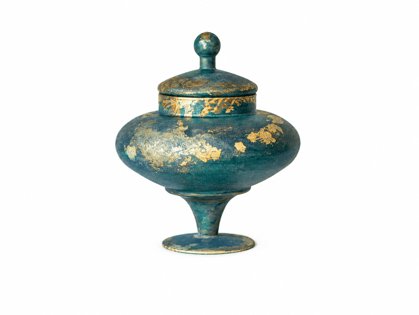 Close view of a rounded teal memorial vessel with hand-applied gold leaf